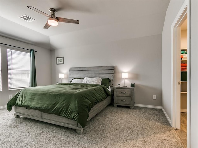 carpeted bedroom featuring lofted ceiling and ceiling fan