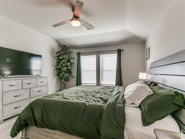 carpeted bedroom with vaulted ceiling and ceiling fan