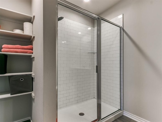 bathroom featuring a shower with shower door