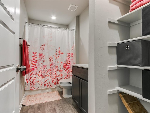 full bathroom featuring shower / bath combination with curtain, vanity, toilet, and hardwood / wood-style floors