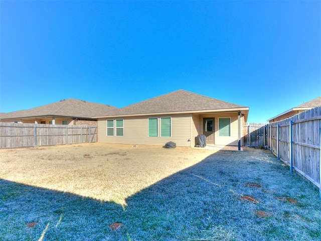 rear view of house with a lawn