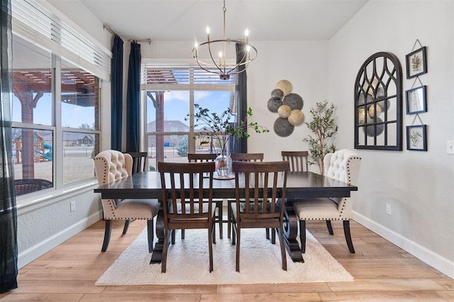 dining room featuring an inviting chandelier and light hardwood / wood-style flooring