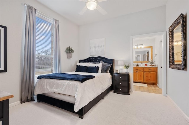 carpeted bedroom with ceiling fan and ensuite bathroom