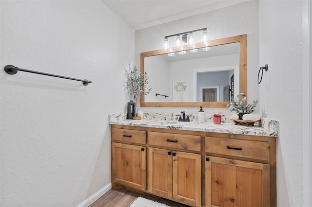 bathroom featuring hardwood / wood-style flooring and vanity