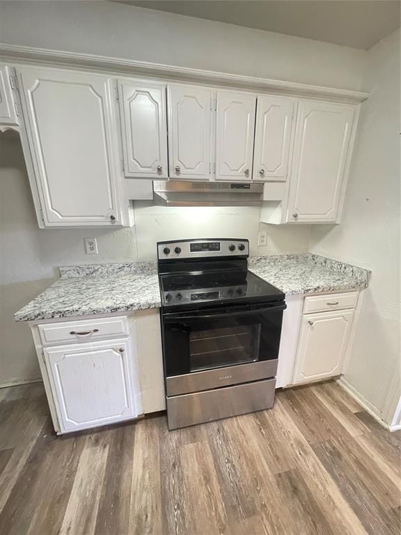 kitchen with white cabinetry, hardwood / wood-style floors, electric range, and light stone counters