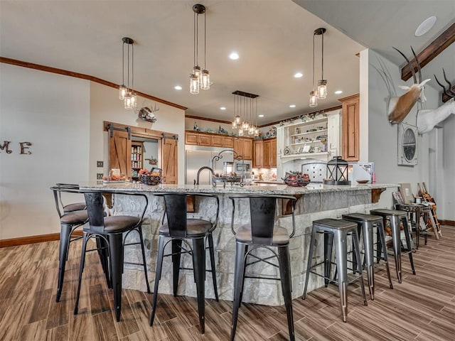 kitchen with pendant lighting, a kitchen bar, and kitchen peninsula