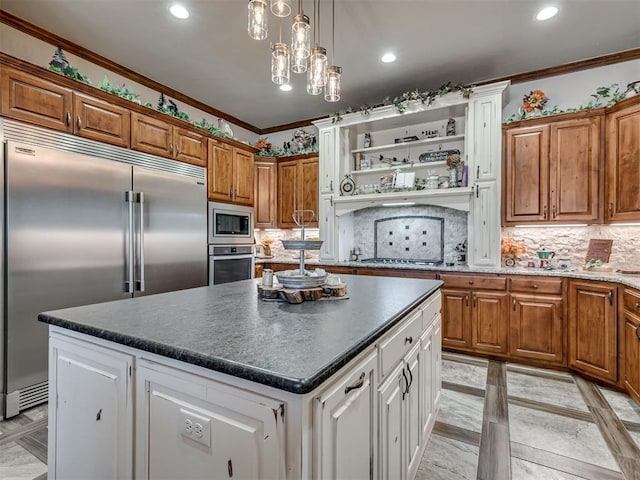 kitchen featuring built in appliances, decorative backsplash, ornamental molding, and a kitchen island