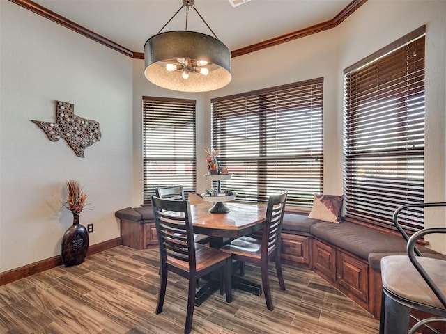 dining space with ornamental molding and hardwood / wood-style floors