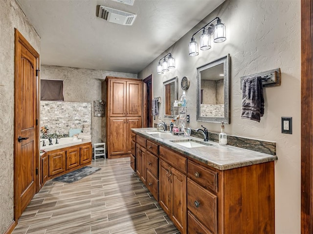 bathroom featuring vanity and a washtub