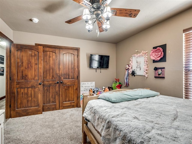 bedroom with ceiling fan, a closet, and carpet