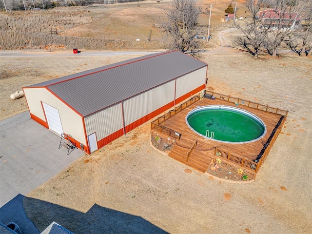 view of swimming pool with an outbuilding