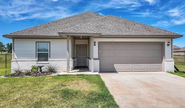 view of front of house featuring a garage and a front lawn