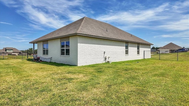 view of side of property with a lawn