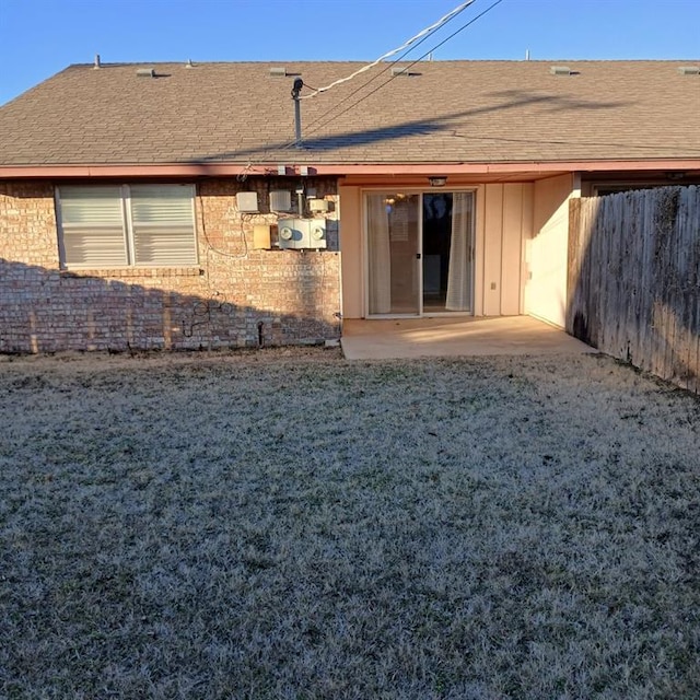 back of property featuring a lawn and a patio