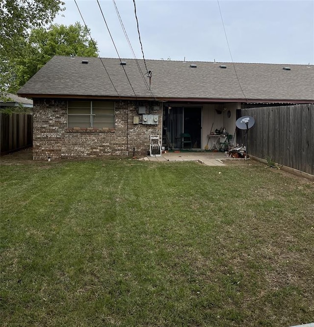 back of house with a yard and a patio area