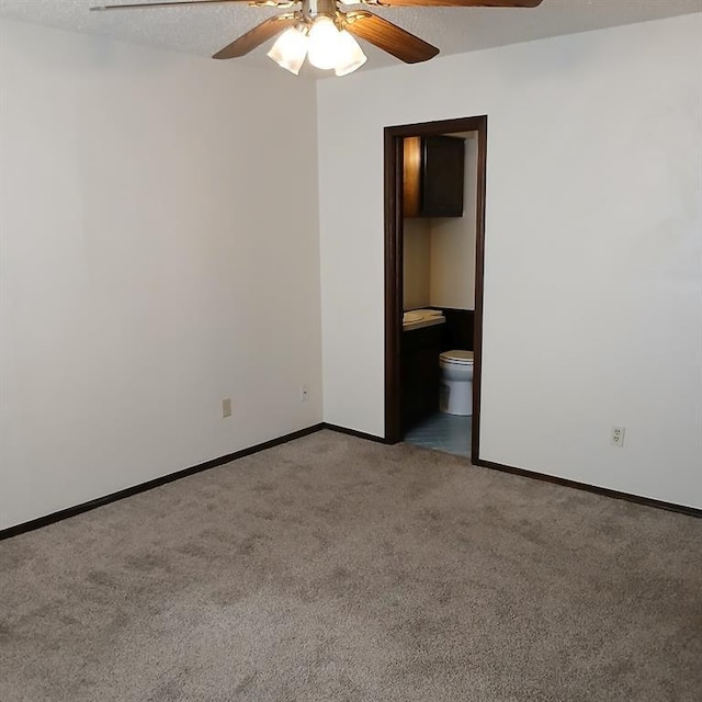 empty room featuring light carpet, a textured ceiling, and ceiling fan