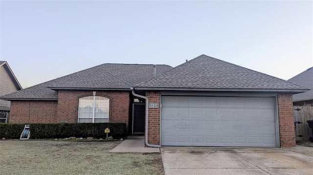 ranch-style house with a garage and a front lawn