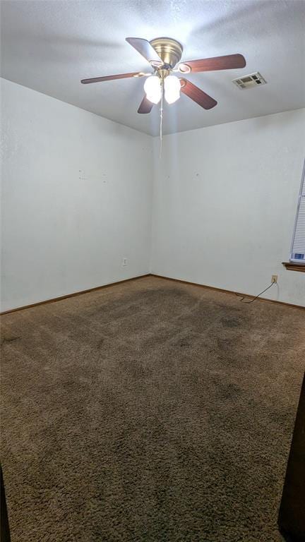 unfurnished room with ceiling fan, carpet flooring, and a textured ceiling