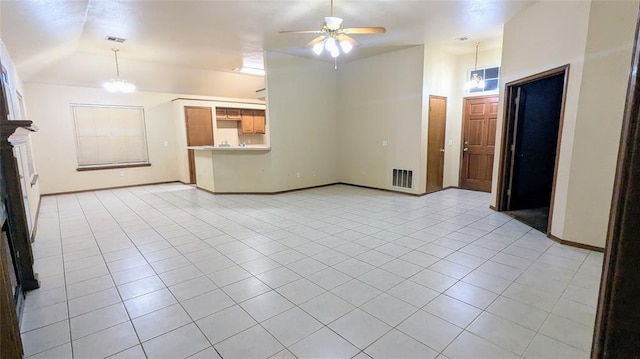 unfurnished living room with high vaulted ceiling, ceiling fan with notable chandelier, and light tile patterned floors