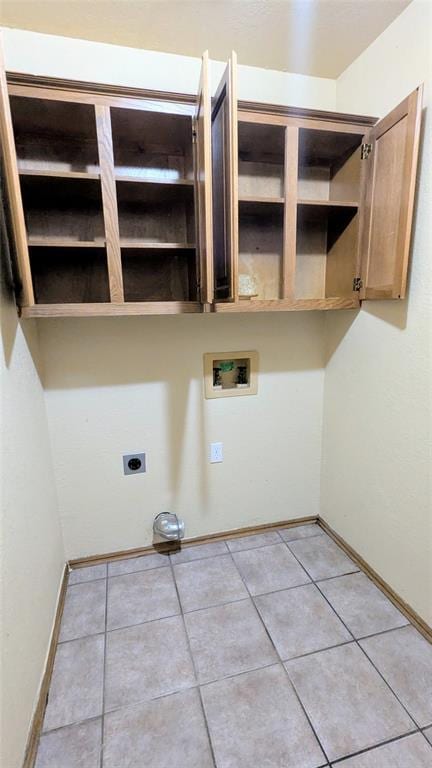 laundry area with electric dryer hookup, washer hookup, and light tile patterned floors