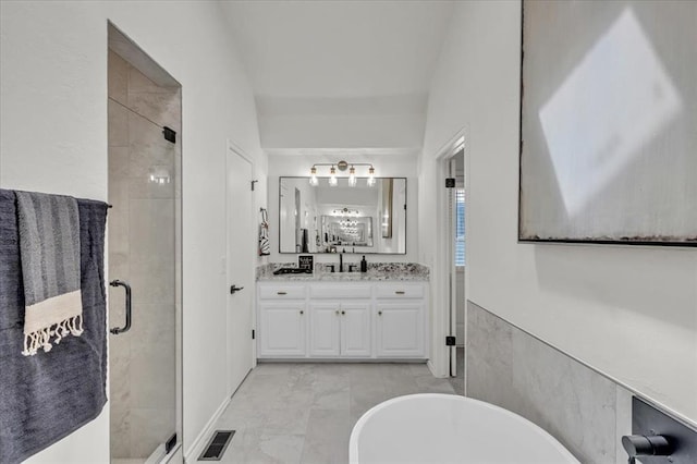 bathroom featuring vanity and plus walk in shower