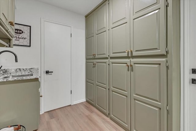 interior space with sink and light hardwood / wood-style flooring