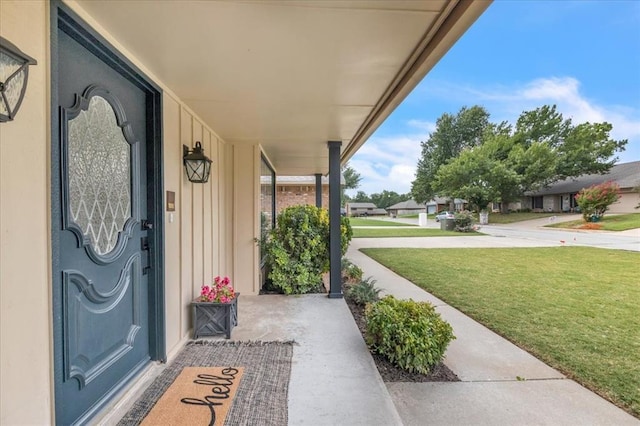 entrance to property featuring a lawn