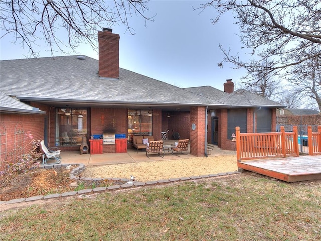 rear view of house with a patio area, a lawn, ceiling fan, an outdoor living space, and a wooden deck