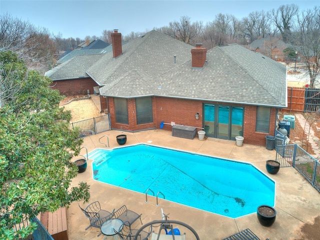 view of pool with a patio and central AC