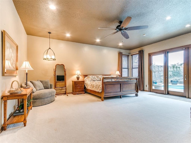 carpeted bedroom featuring a textured ceiling and access to exterior