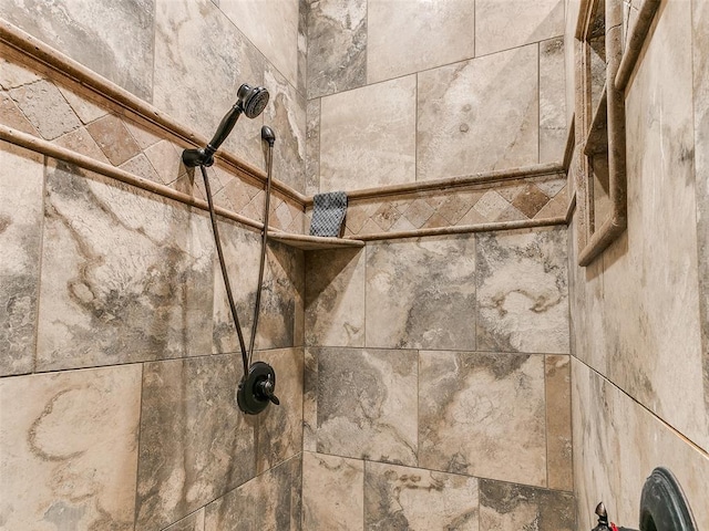 interior details featuring a tile shower