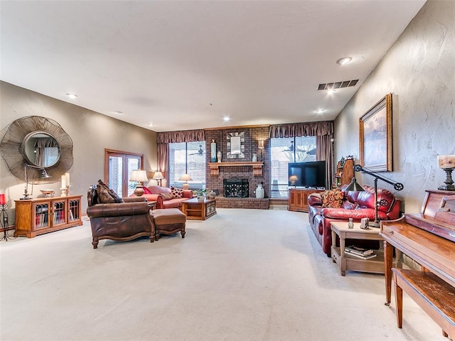 living room featuring light carpet, a healthy amount of sunlight, and a fireplace