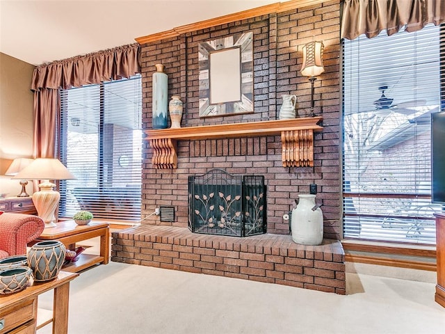 living room with a fireplace and ceiling fan