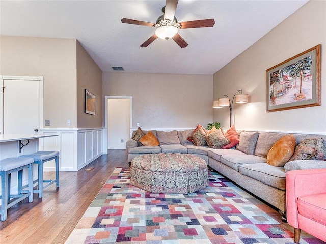 living room with light wood-type flooring and ceiling fan