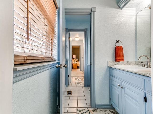 bathroom featuring tile patterned flooring and vanity