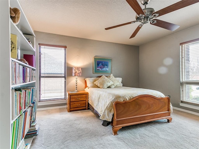 bedroom with carpet, multiple windows, and a textured ceiling