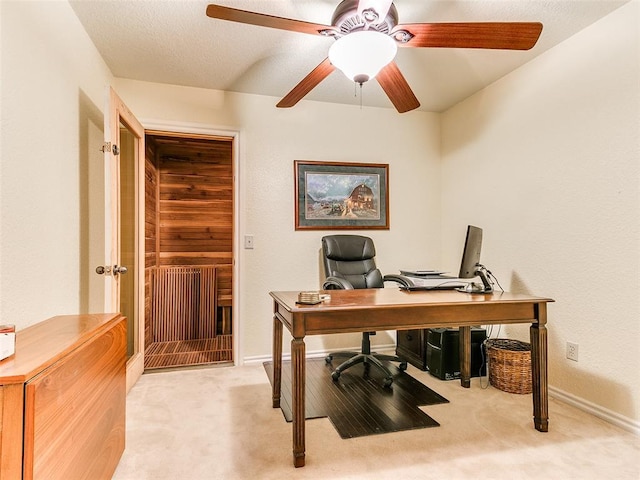 office space featuring ceiling fan and light carpet