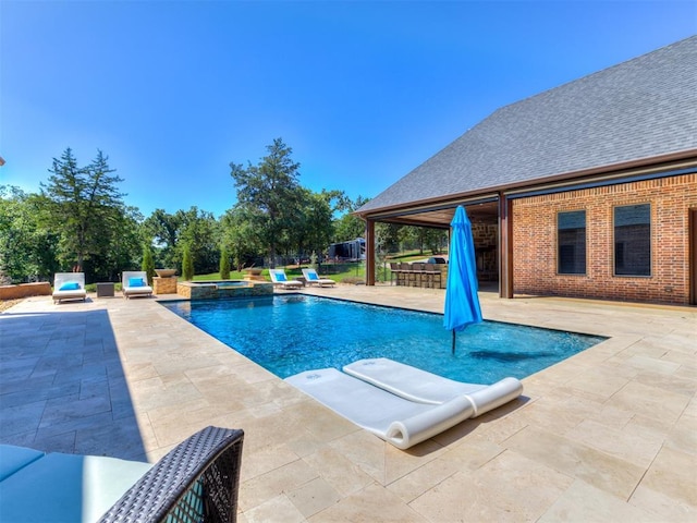 view of pool featuring a patio, an outdoor bar, and an in ground hot tub