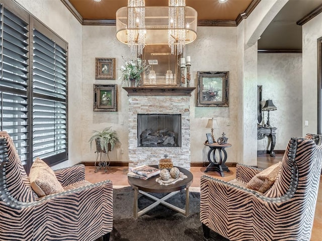 living room with crown molding and a stone fireplace