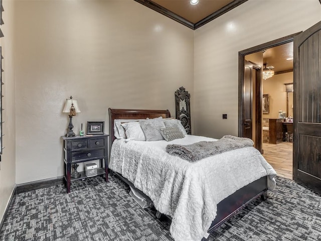 bedroom with crown molding and ensuite bath