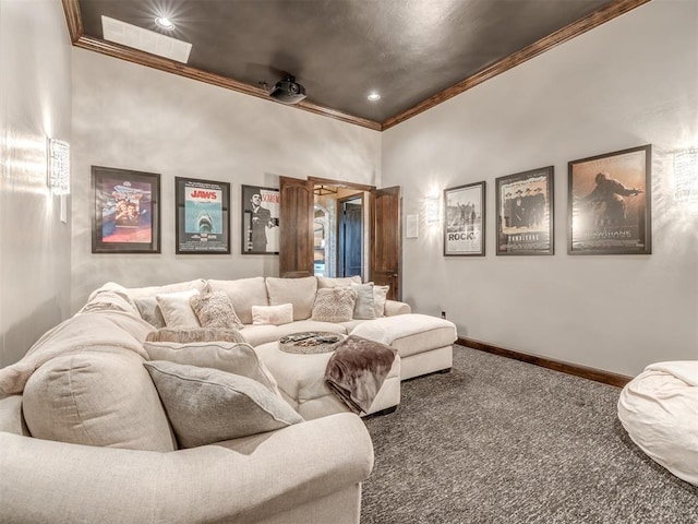 carpeted home theater featuring crown molding