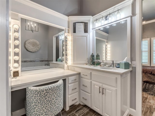 bathroom with vanity, a bathtub, and crown molding