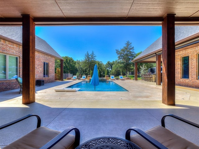 view of swimming pool featuring exterior bar and a patio