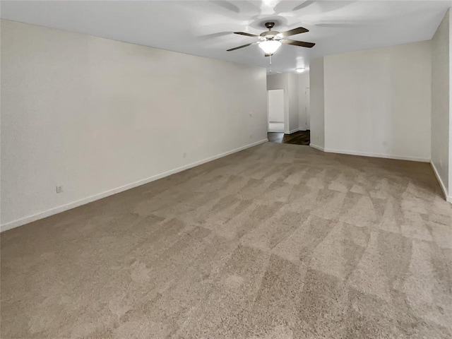 spare room featuring ceiling fan and carpet