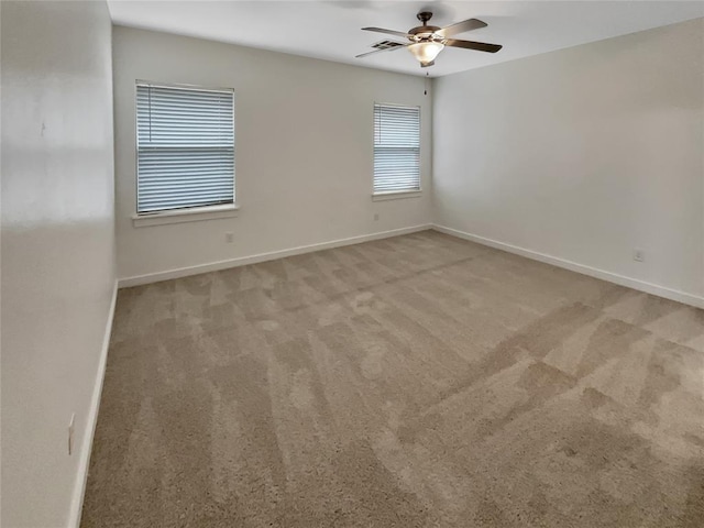 carpeted spare room with ceiling fan