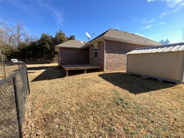 exterior space with a storage shed and a lawn