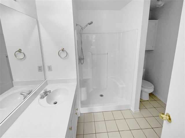 bathroom featuring vanity, tile patterned floors, toilet, and walk in shower