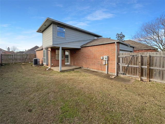 back of property featuring a yard, a patio area, and central air condition unit