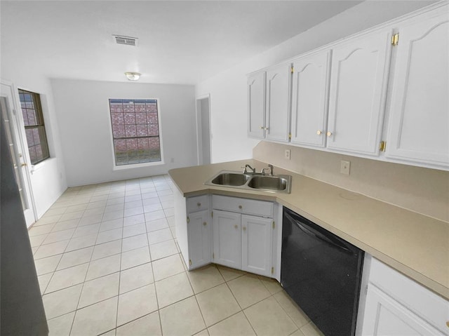 kitchen featuring white cabinetry, light tile patterned flooring, black dishwasher, and sink