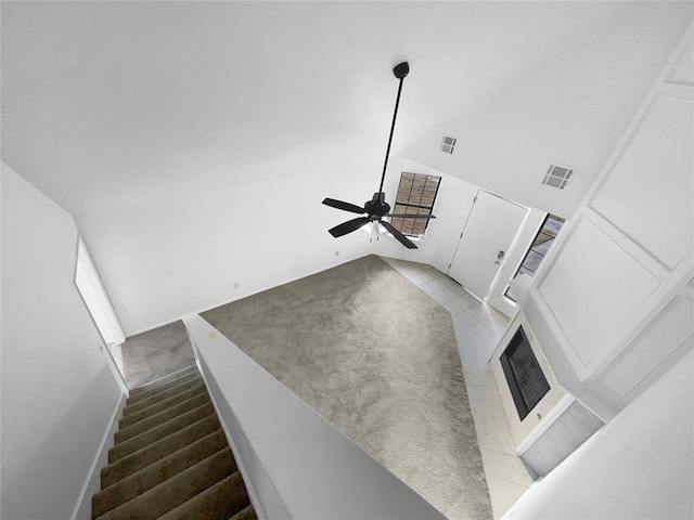 living room featuring ceiling fan and vaulted ceiling